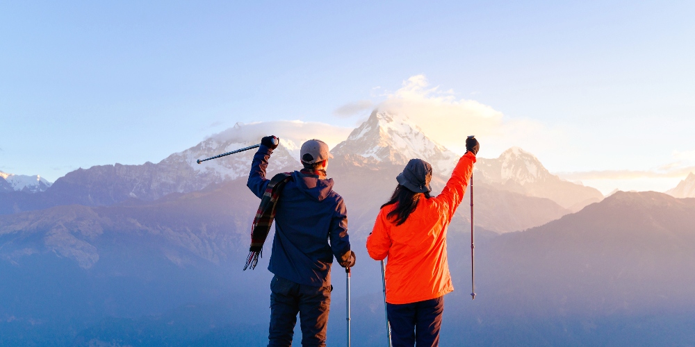 A young couple travellers trekking in Poon Hill
